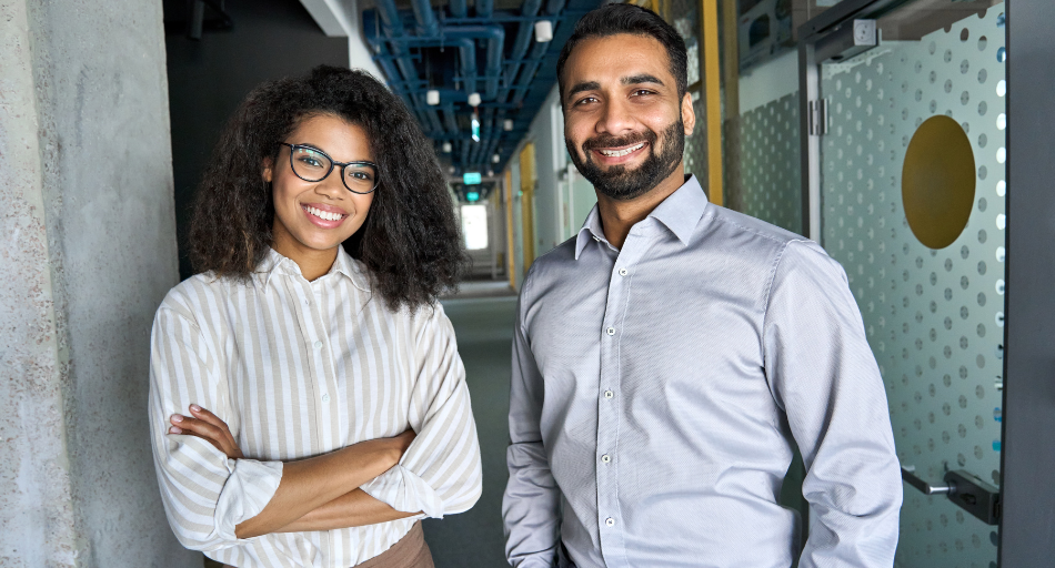 two smiling colleagues in industrial office space