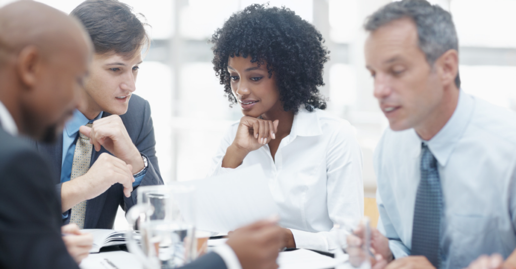 four people meeting to select a staffing agency